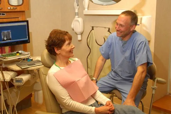 Dr. Harris talking with a patient in operatory room