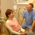 Dr. Harris talking with a patient in operatory room